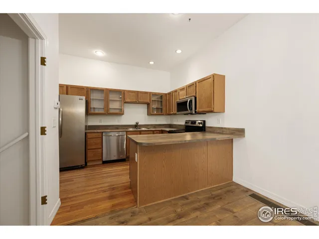 a kitchen with stainless steel appliances granite countertop a refrigerator and a stove