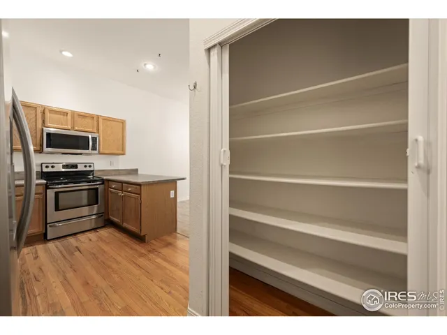a kitchen with a refrigerator and a stove top oven