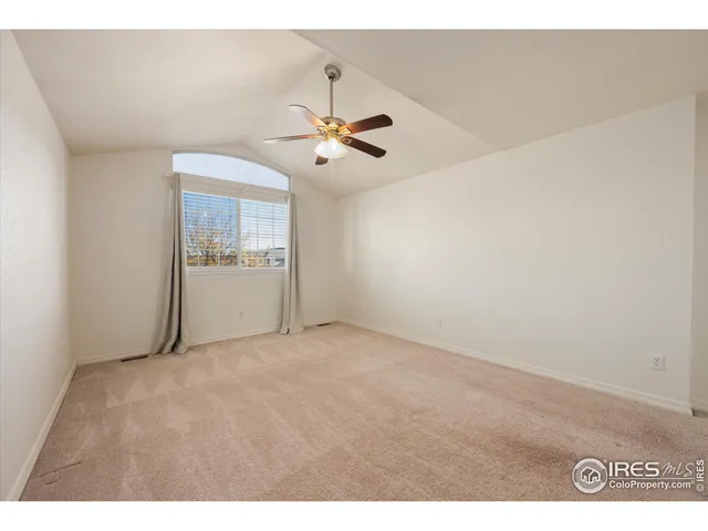 a view of empty room with ceiling fan