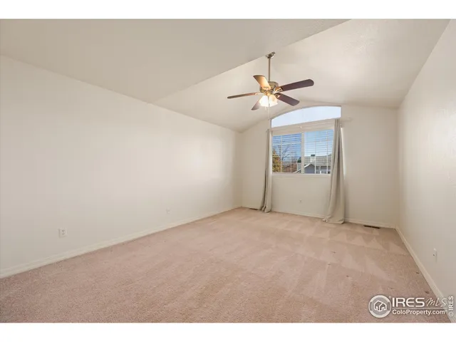 a view of an empty room with a ceiling fan
