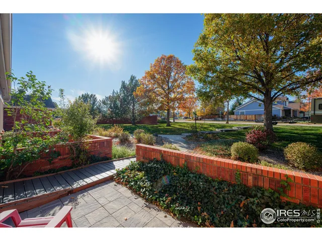 a view of a garden with sitting area
