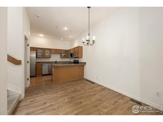 a view of kitchen refrigerator and microwave