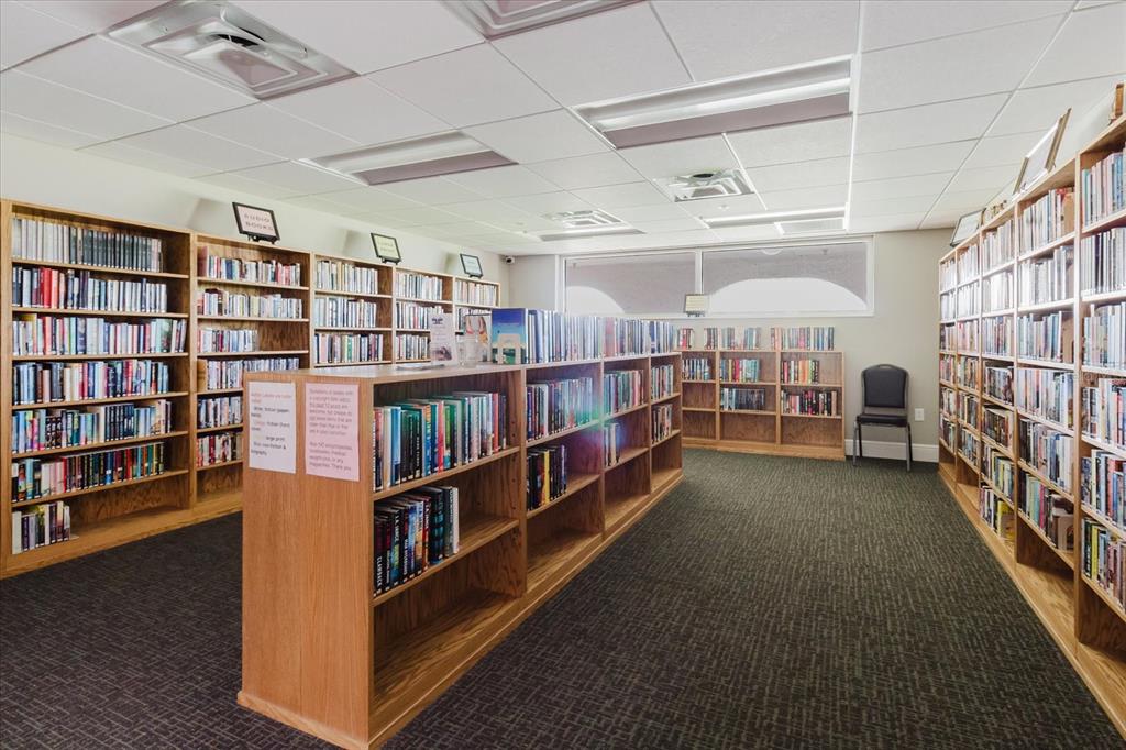 11521 Rose Tree Drive New Port Richey, FL 34654 - Photo 27 of 37 a room with lots of furniture and a book shelf