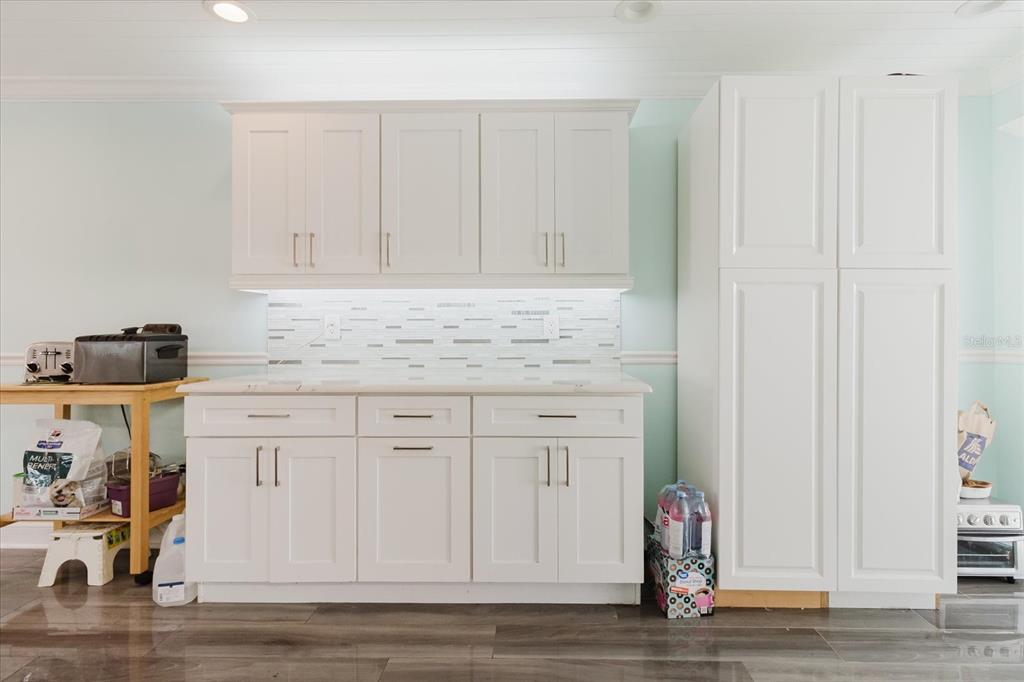 11521 Rose Tree Drive New Port Richey, FL 34654 - Photo 8 of 37 a kitchen with granite countertop white cabinets and sink