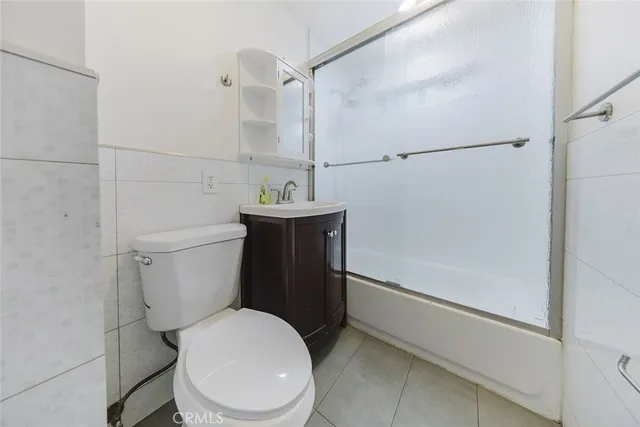 a white toilet sitting next to a bath tub