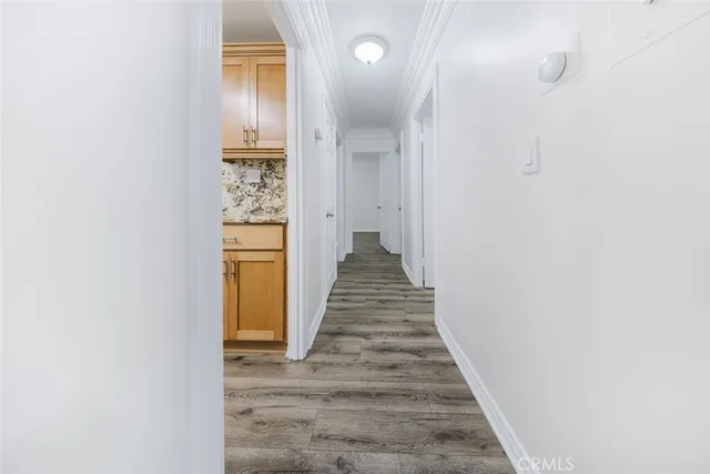 a view of a hallway with wooden floor and staircase