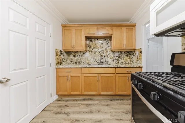 a kitchen with stainless steel appliances granite countertop a stove and a refrigerator