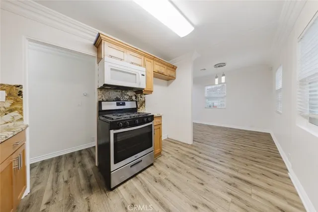 a kitchen with wooden floors and a stove top oven