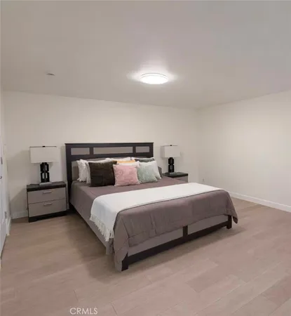 a bedroom with a bed and a lamp