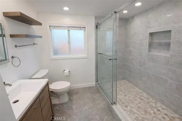 a bathroom with a sink toilet and shower