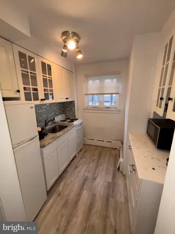 a kitchen with granite countertop a sink and a stove top oven