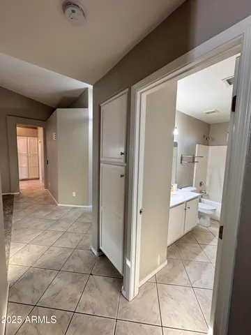 a bathroom with a glass door shower a sink and a toilet