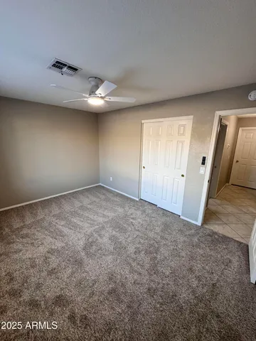 an empty room with a wooden floor and windows