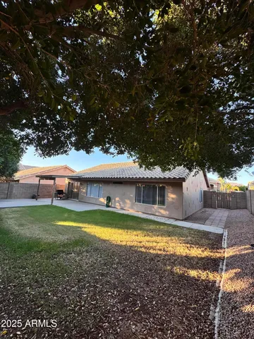 a view of a house with swimming pool and a yard