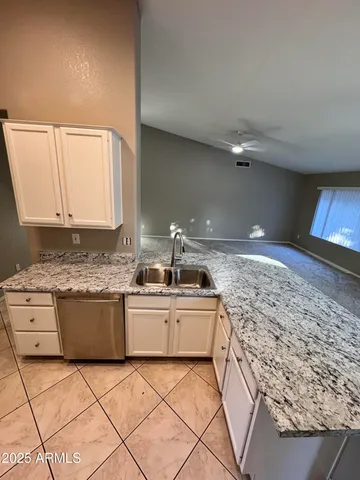 a kitchen with granite countertop a sink and a stove