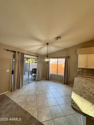 a large room with a large window and chandelier