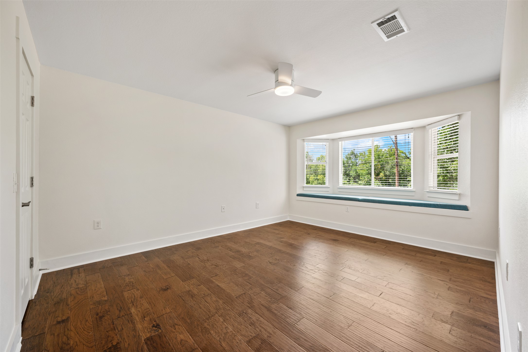 4912 Sara Drive, Unit A Austin, TX 78721 - Photo 18 of 28 Spacious primary bedroom with bay window overlooking the park and room for a king-size bed.