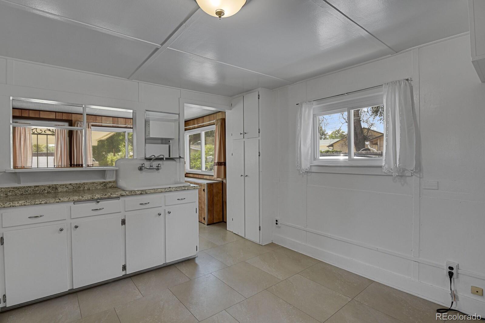 12400 West 44th Avenue Wheat Ridge, CO 80033 - Photo 14 of 31 a spacious bathroom with a granite countertop sink mirror and window