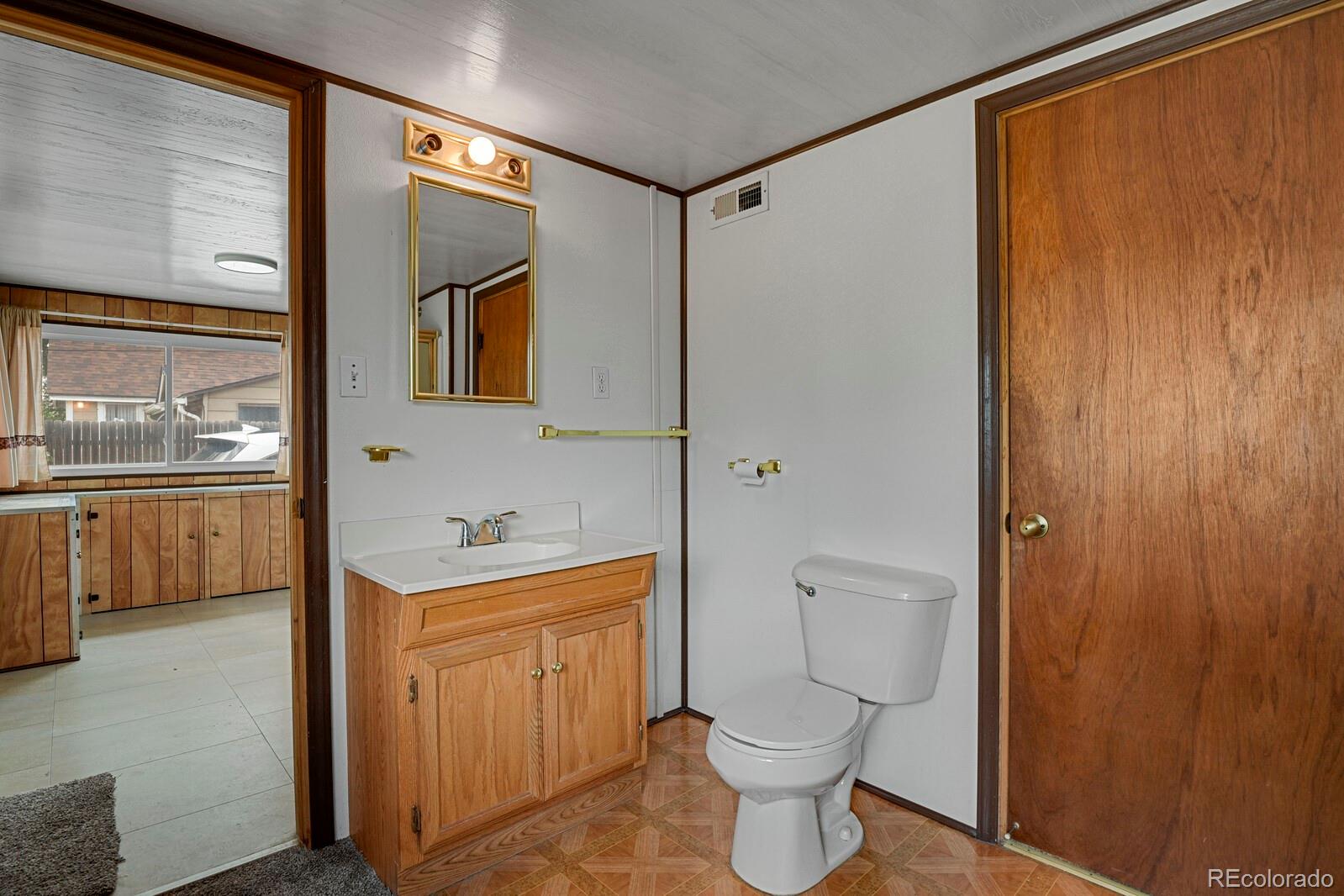 12400 West 44th Avenue Wheat Ridge, CO 80033 - Photo 17 of 31 a bathroom with a sink a toilet and shower
