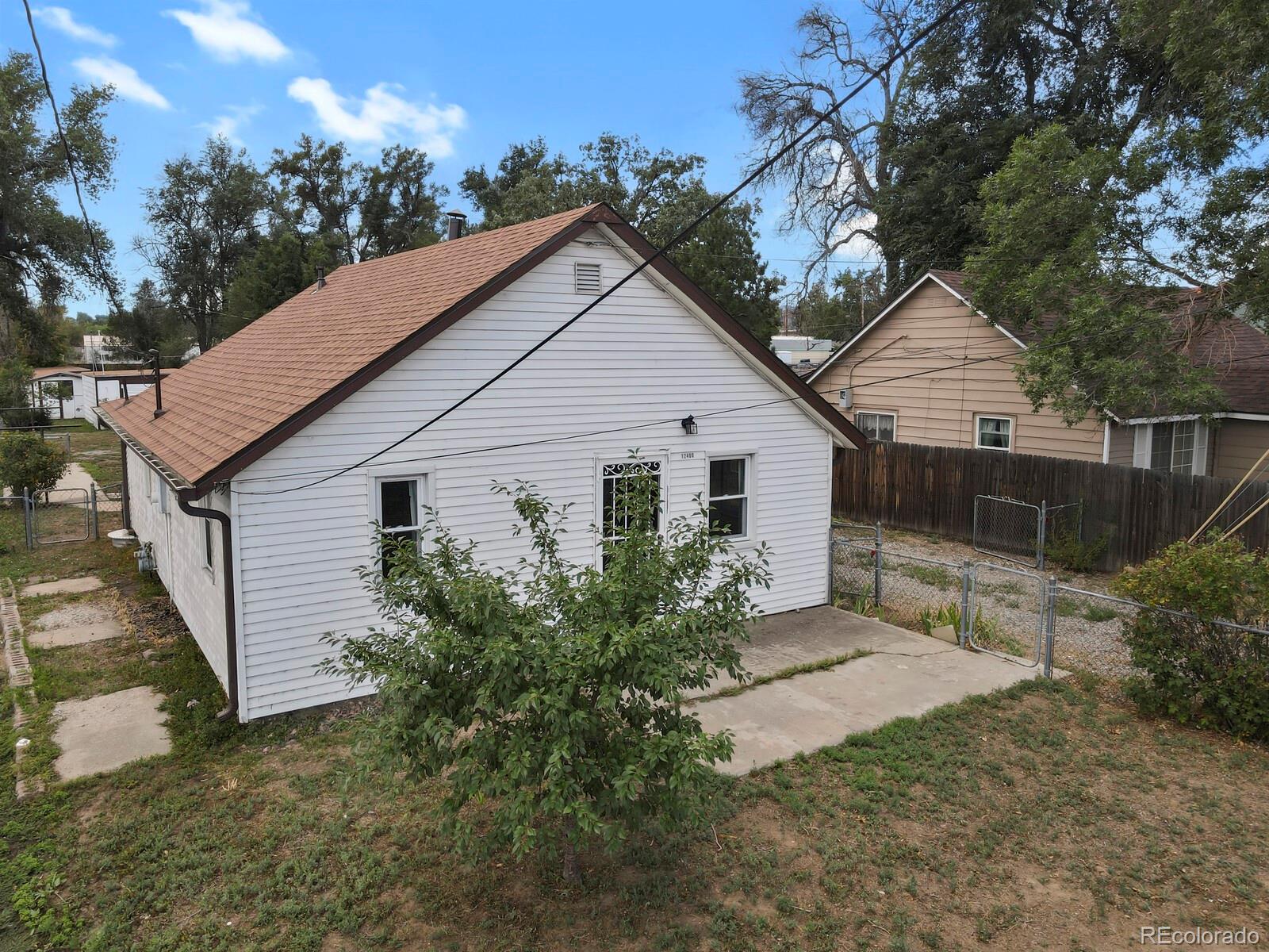 12400 West 44th Avenue Wheat Ridge, CO 80033 - Photo 25 of 31 a view of a house with a yard and a garden