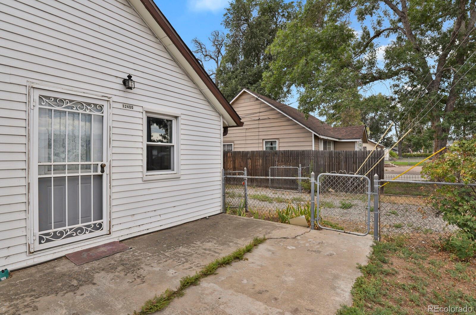 12400 West 44th Avenue Wheat Ridge, CO 80033 - Photo 4 of 31 a view of a small house and a yard