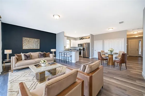 a living room with furniture and wooden floor