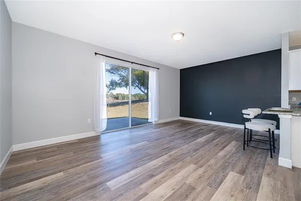 a view of room with wooden floor and a window