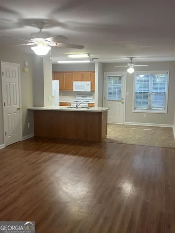 a view of kitchen and hall with wooden floor