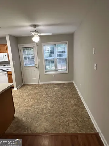 en empty room with wooden floor and window