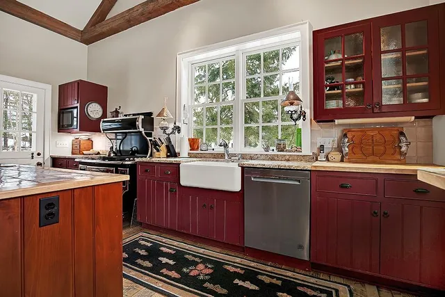 a kitchen with stainless steel appliances granite countertop a sink stove and cabinets