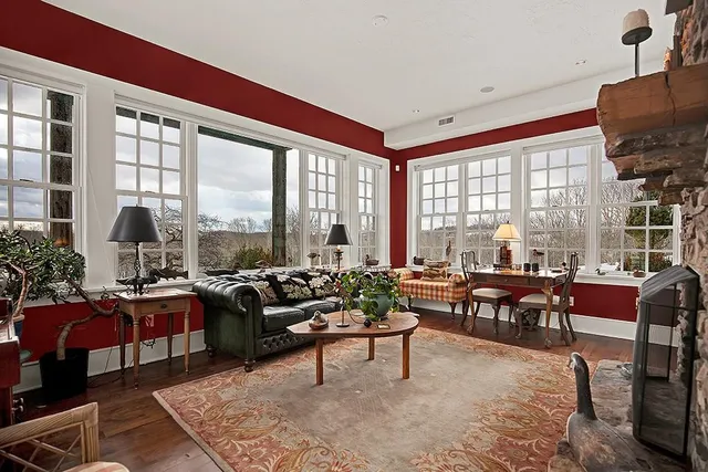 a living room with furniture and large windows