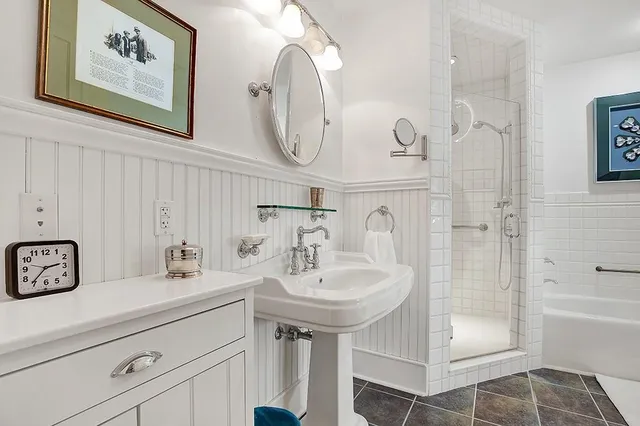 a bathroom with a sink a mirror and a shower