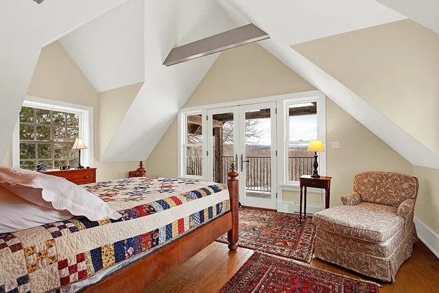 a bedroom with a bed couch and a window