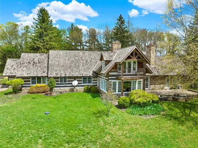 a aerial view of a house with a big yard and potted plants