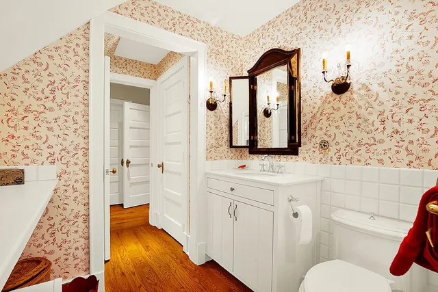 a bathroom with a toilet a sink and mirror