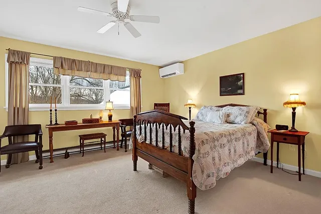 a spacious bedroom with a bed and a chandelier