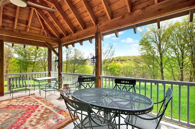 a view of a patio with a table chairs and a backyard