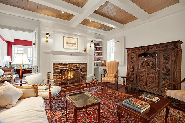 a living room with furniture a fireplace and a large window