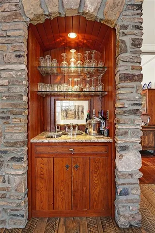 a kitchen with granite countertop a stove and cabinets