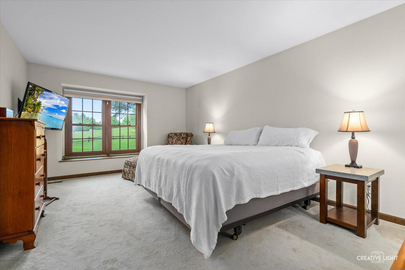 312 Dunham Place Commons, Unit 312 St. Charles, IL 60174 - Photo 12 of 28 a spacious bedroom with a bed and a lamp next to a window