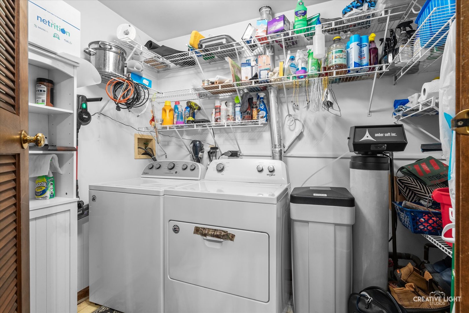 312 Dunham Place Commons, Unit 312 St. Charles, IL 60174 - Photo 21 of 28 a utility room with cabinets dryer and bicycles