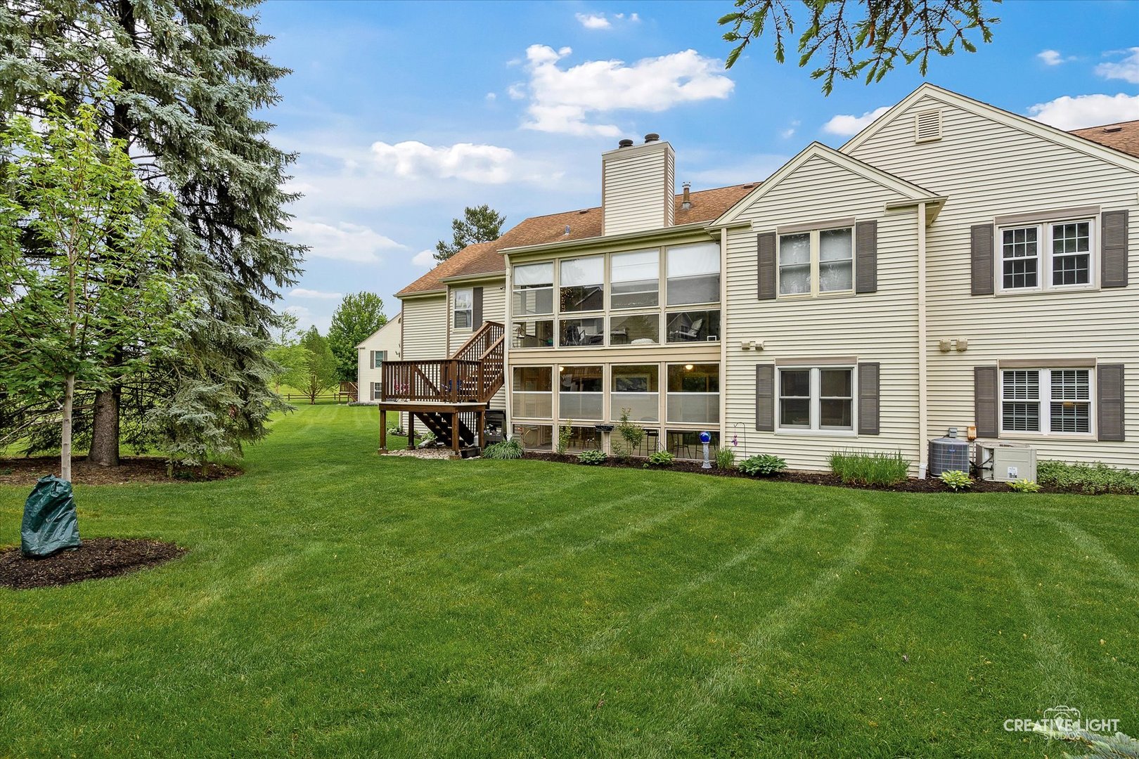 312 Dunham Place Commons, Unit 312 St. Charles, IL 60174 - Photo 25 of 28 a view of a big yard with a large trees and a yard