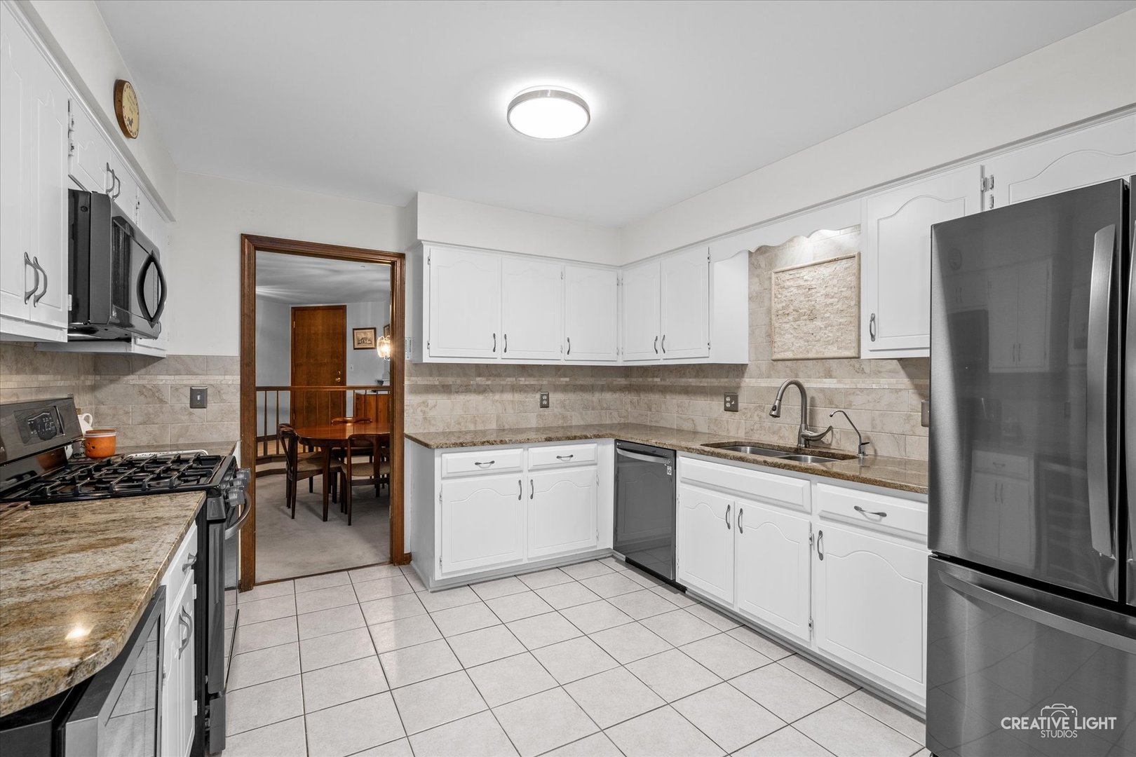 312 Dunham Place Commons, Unit 312 St. Charles, IL 60174 - Photo 5 of 28 a kitchen with a sink a refrigerator and cabinets