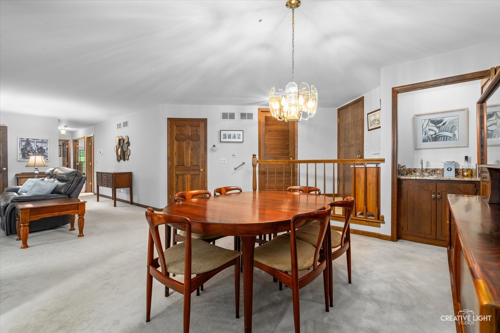312 Dunham Place Commons, Unit 312 St. Charles, IL 60174 - Photo 7 of 28 a dining room with furniture a chandelier and a painting