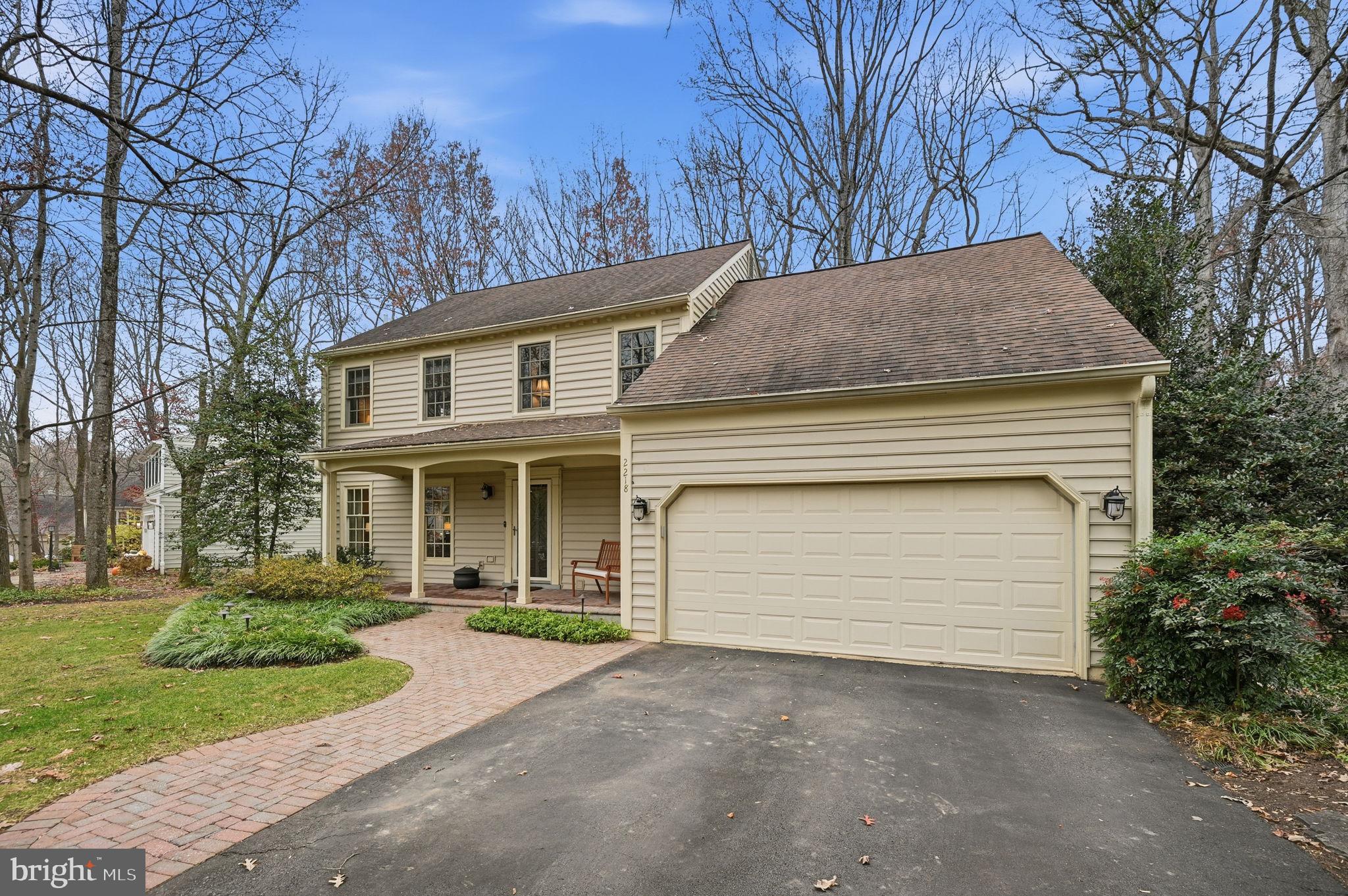 2218 Wakerobin Lane Reston, VA 20191 - Photo 54 of 62 a front view of a house with a garden and trees