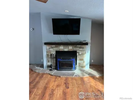 a living room with a fireplace and a flat screen tv