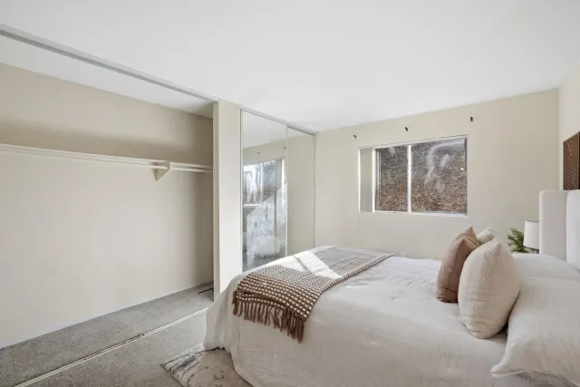 a bedroom with a bed and a window