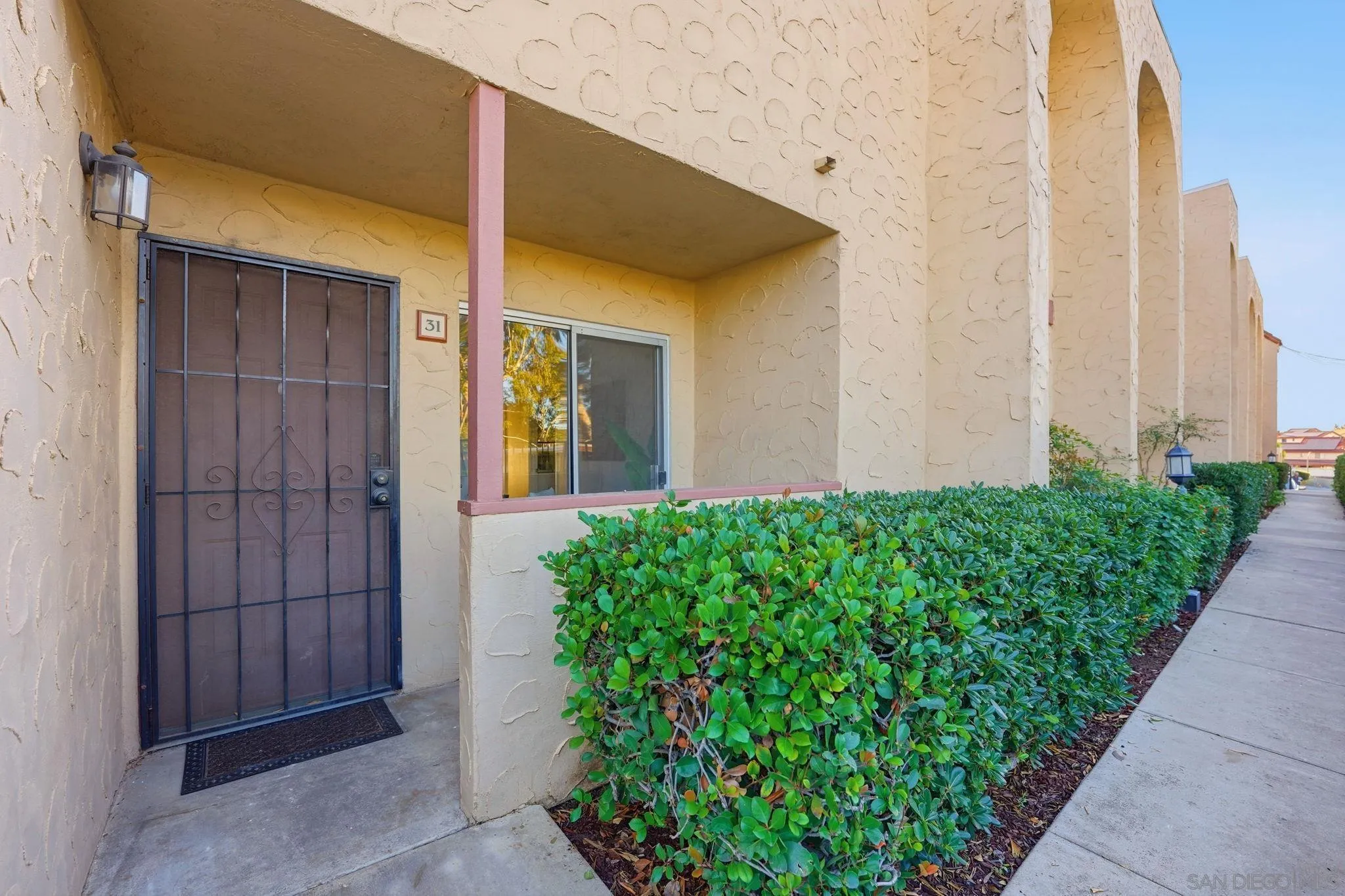 3557 Kenora Drive, Unit 31 Spring Valley, CA 91977 - Photo 16 of 24 a couple of potted plants in front of door