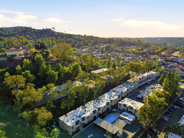 an aerial view of residential houses with outdoor space