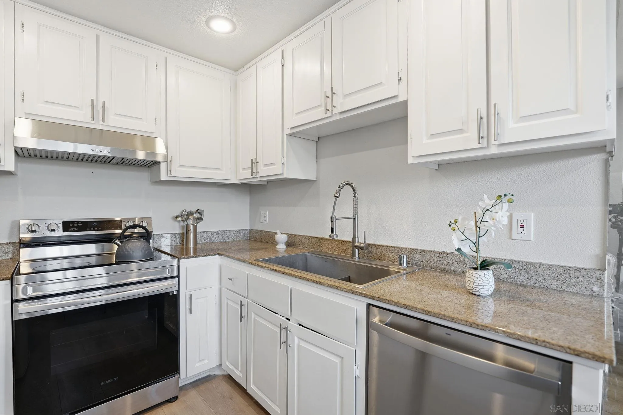 3557 Kenora Drive, Unit 31 Spring Valley, CA 91977 - Photo 5 of 24 a kitchen with appliances cabinets and a counter top